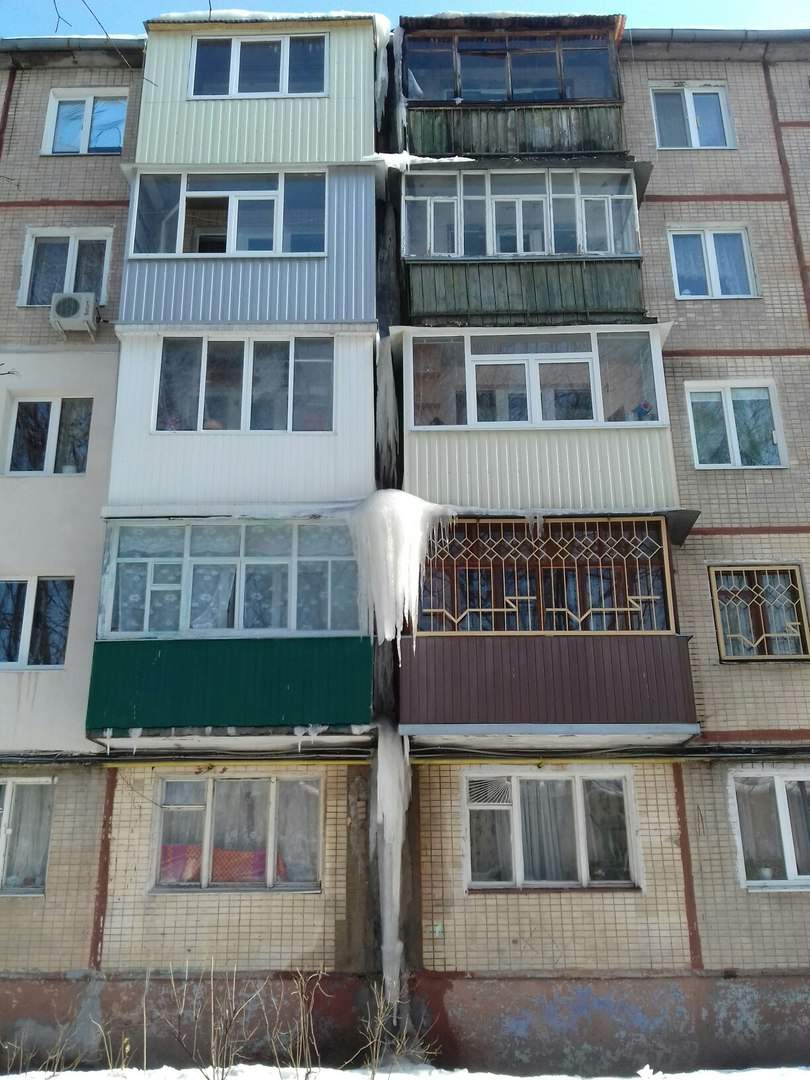 Зимние опасности: в Харькове с балконов жилого дома свисают глыбы спрессованного снега (фото)